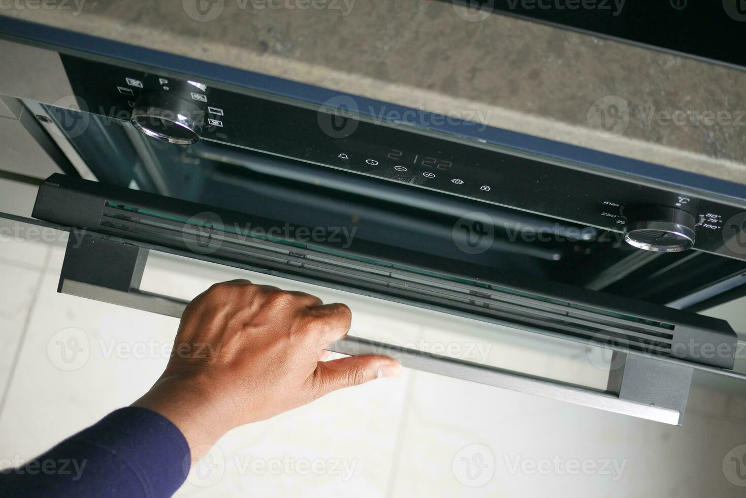 top view of hand open electric oven at home photo