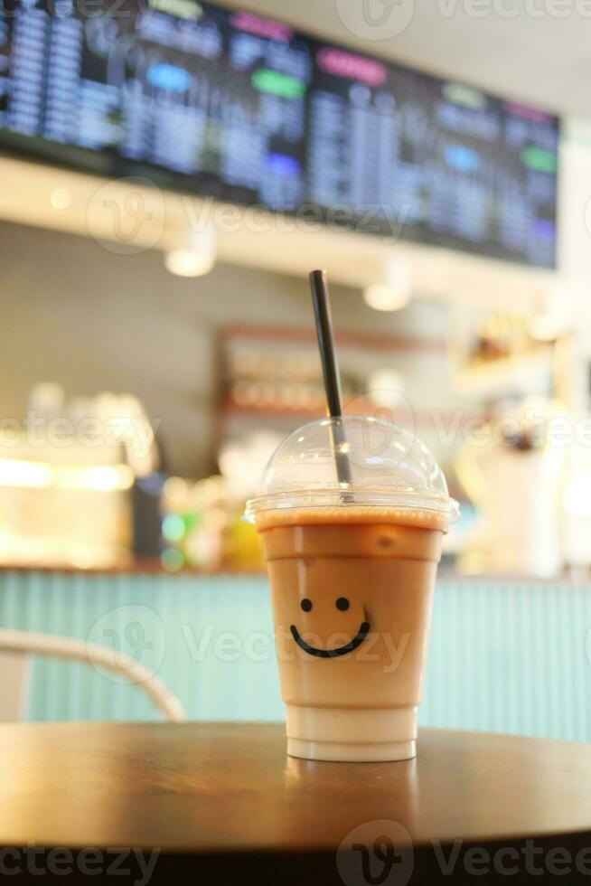 cold coffee in a plastic container with smile shape design on it photo