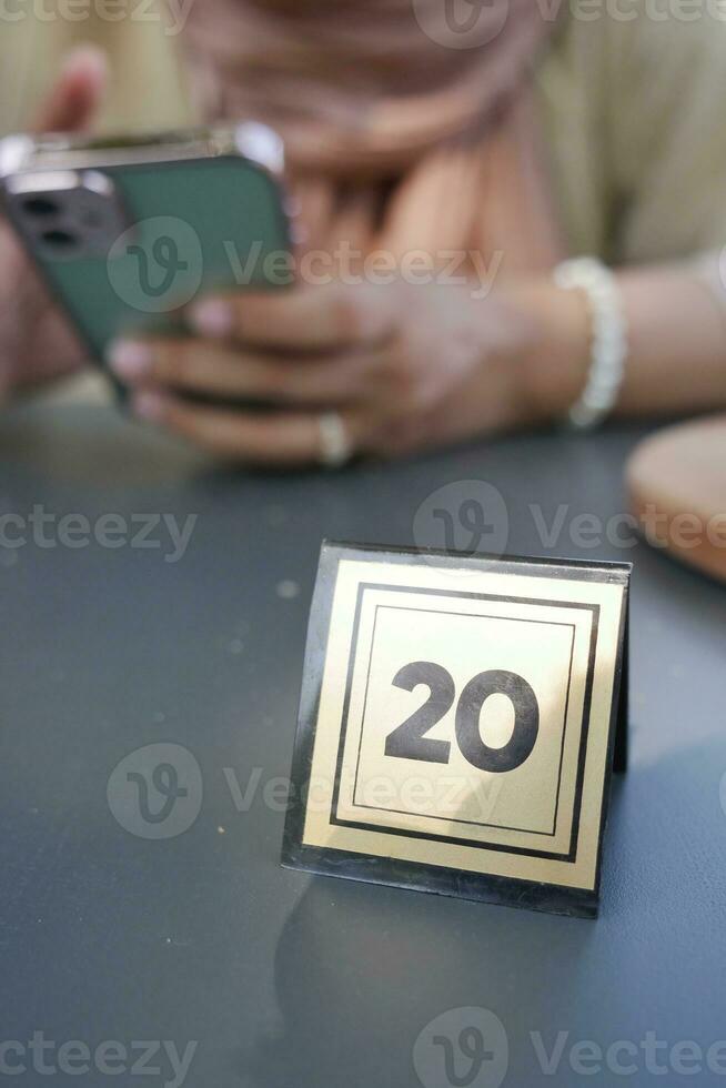 20 number sign number on cafe table . photo