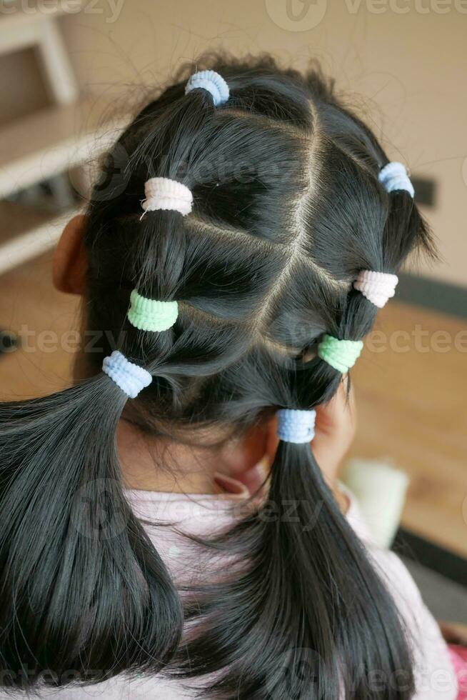 Beautiful ribbon is tied on a child hair photo