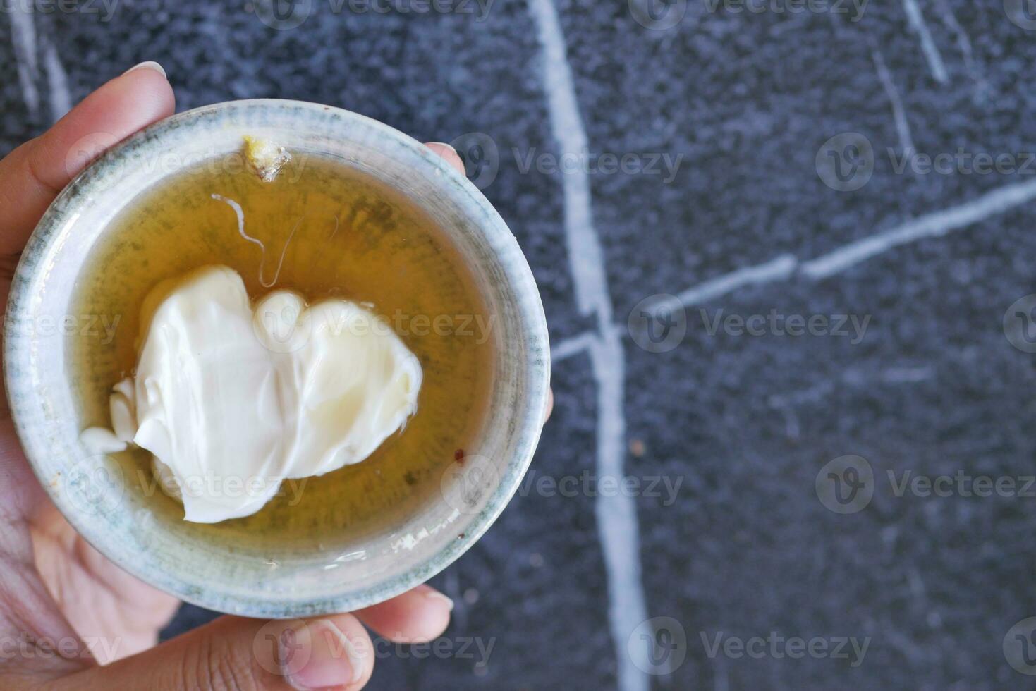 butter cream and honey in a bowl on table . photo