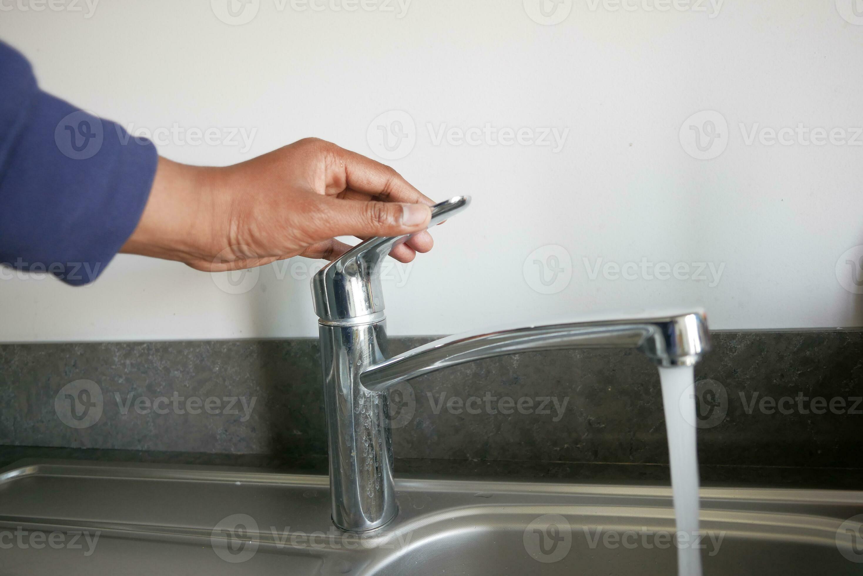 water pouring from a faucet tap slow motion 32036516 Stock Photo at