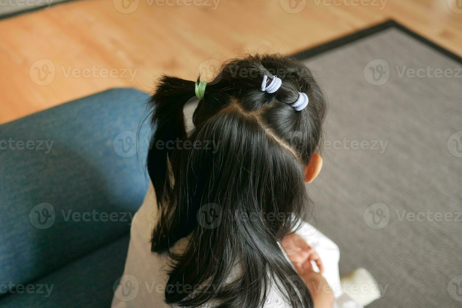 Beautiful ribbon is tied on a child hair photo
