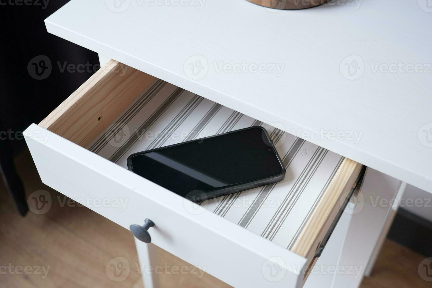 mobile phone in open drawer photo