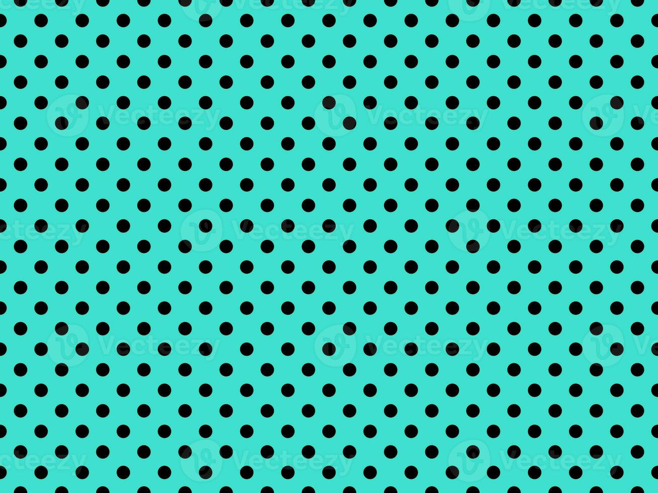 black polka dots over turquoise background photo
