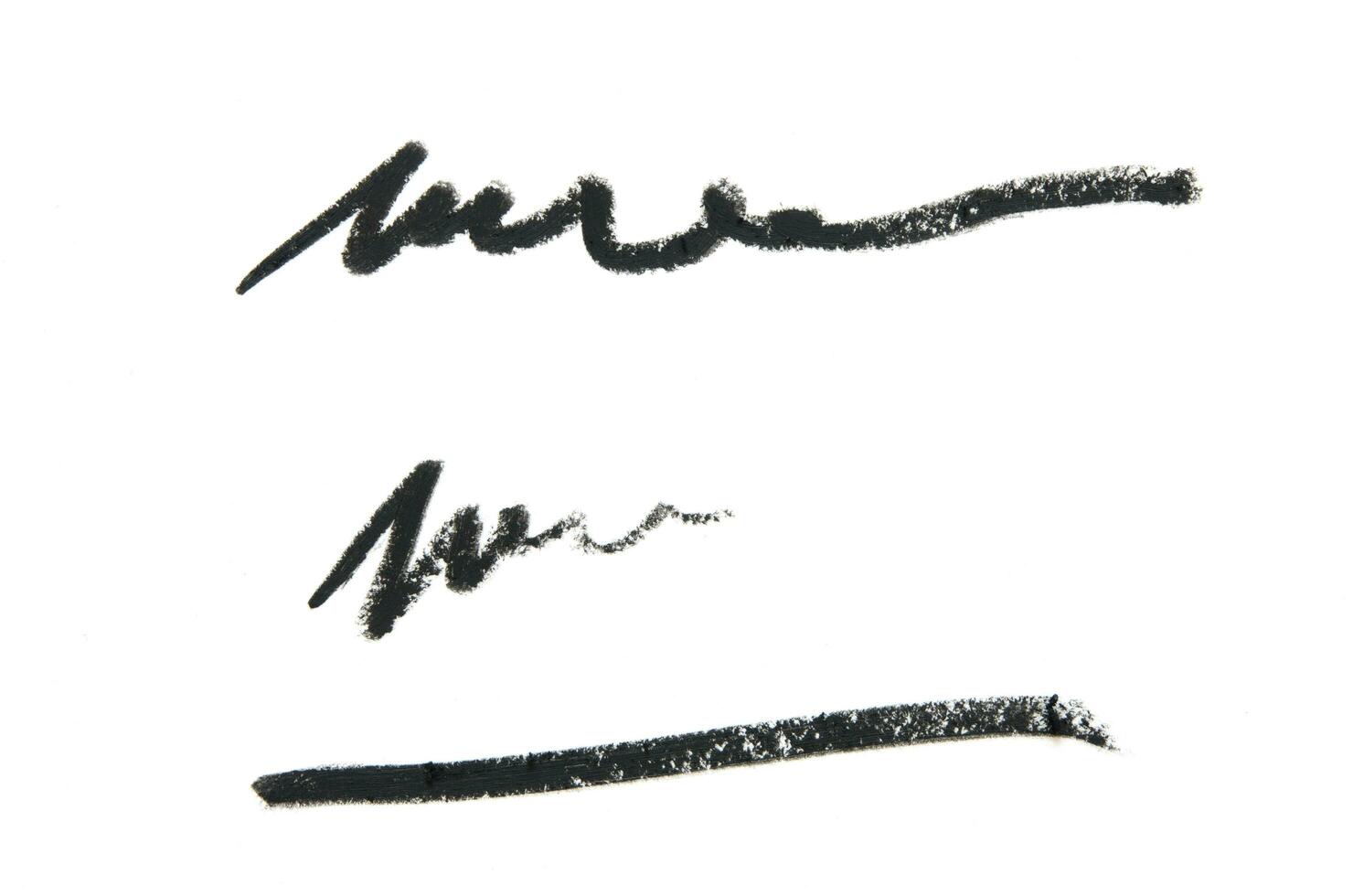 Black color Cosmetic pencil strokes on background. - Image photo