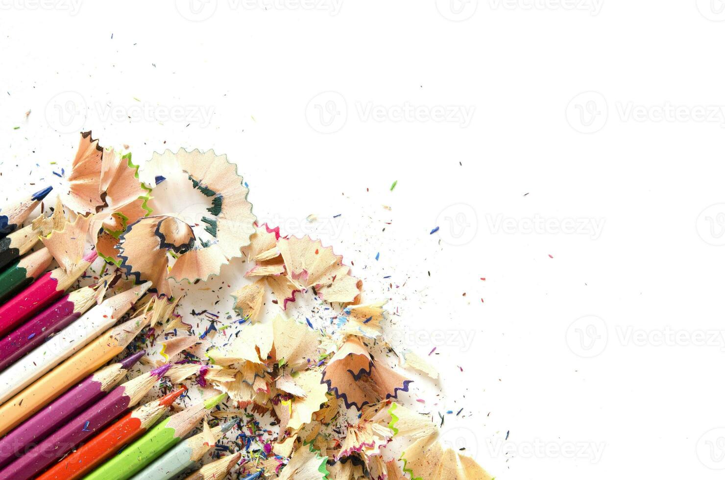 Drawing tools background. Lot of colorful pencils frame with sawdust and shavings on white, copy space, flat lay photo