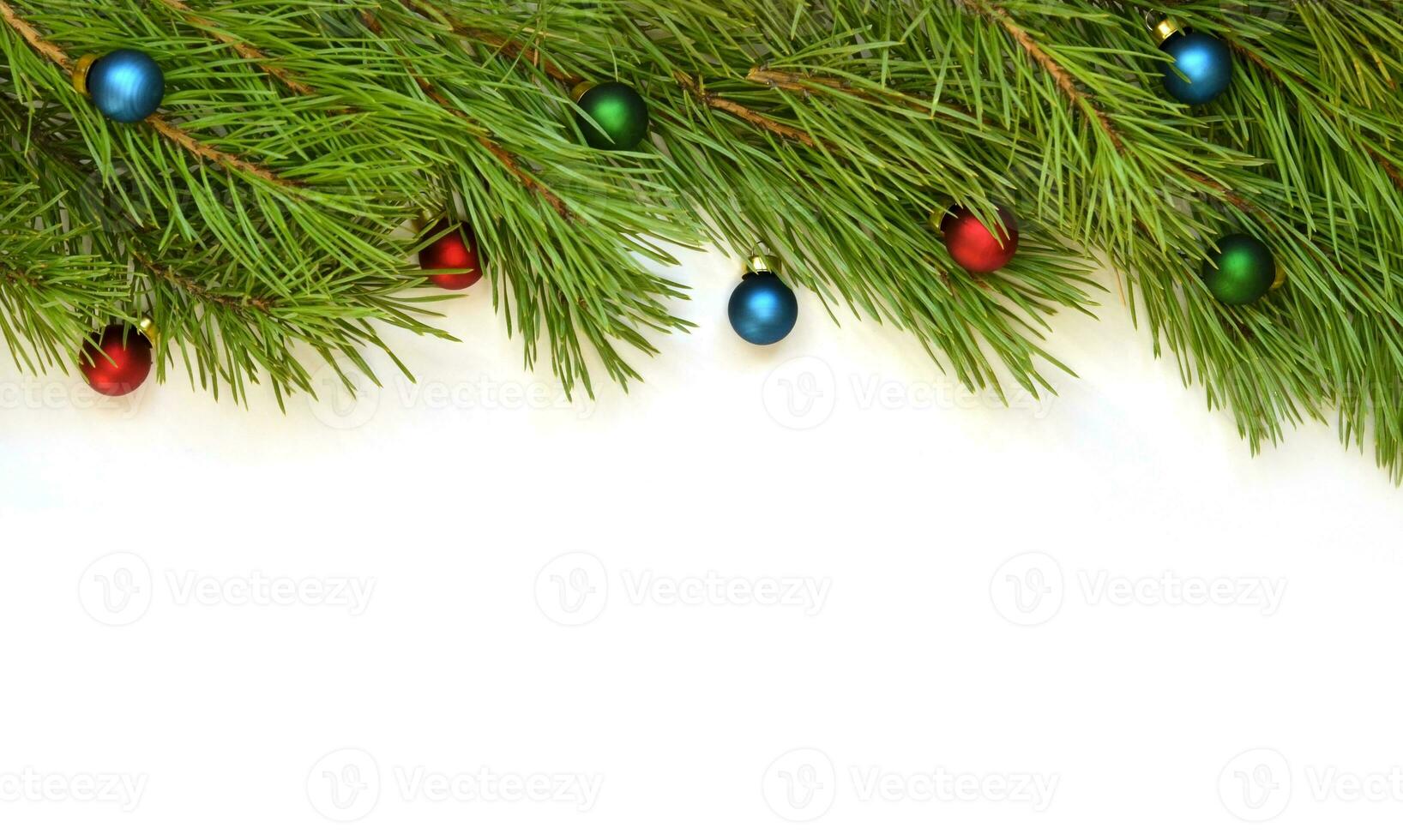 Branch of Christmas tree with balls on white background. photo