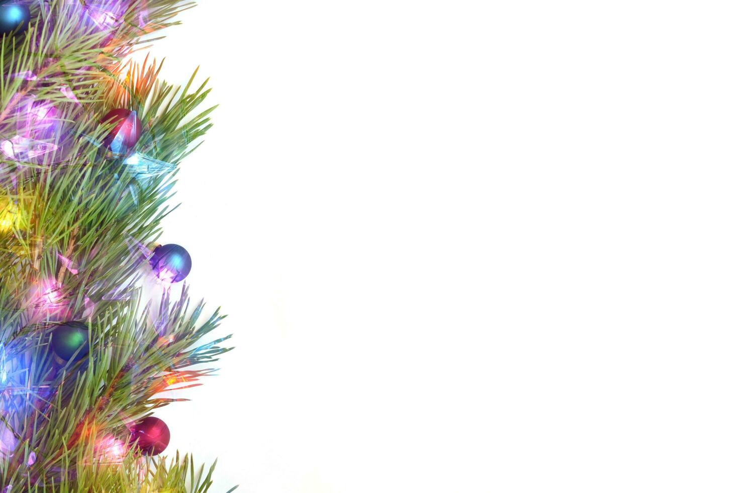 Branch of Christmas tree with balls on white background. photo
