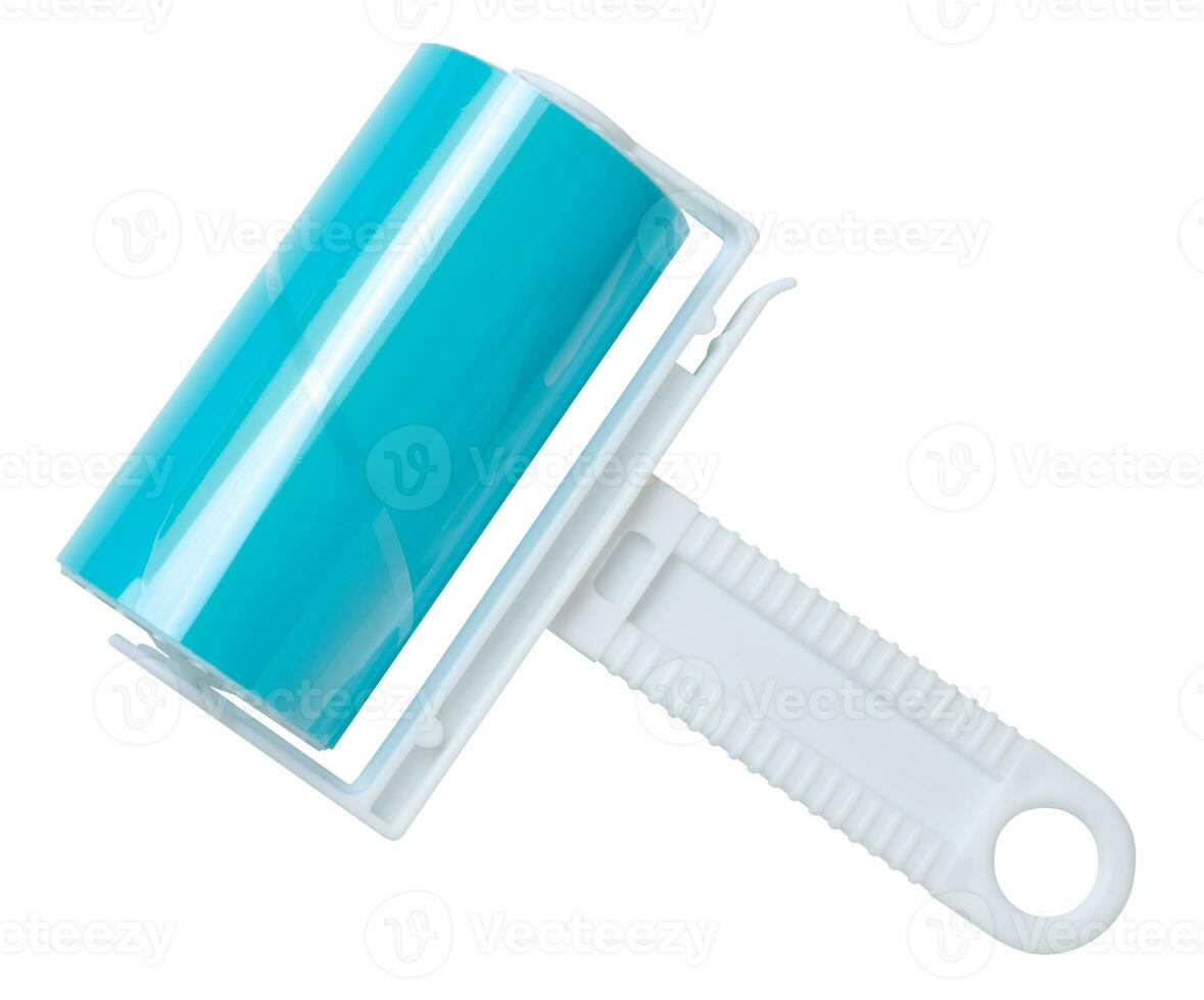 Roller with sticky tape for cleaning clothes on a white background, top view photo