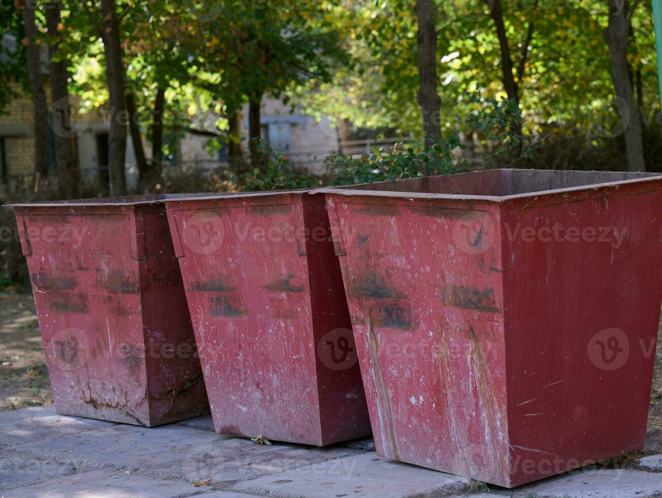 Empty metal trash cans in the park photo