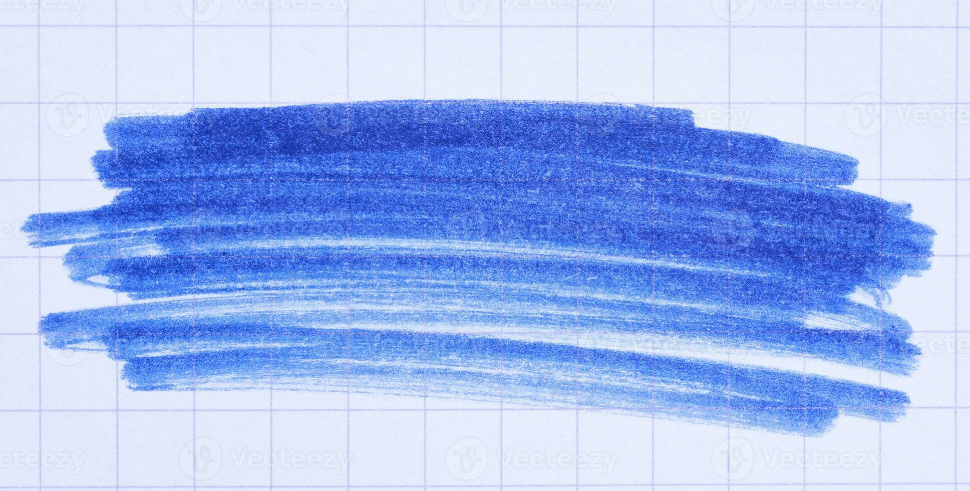 Hatching with a blue felt-tip pen on a sheet of checkered paper photo