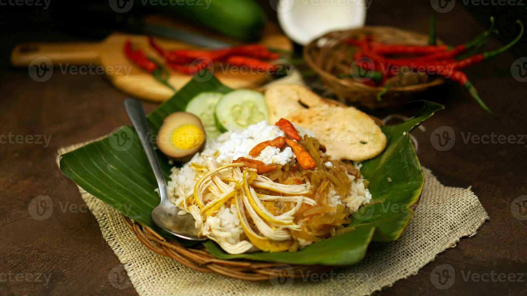 Nasi liwet is a Indonesian traditional food cooked with coconut milk, chicken broth, lemongrass and spices so that it has a savory taste and distinctive aroma. Cucumber and crackers are complementary. photo