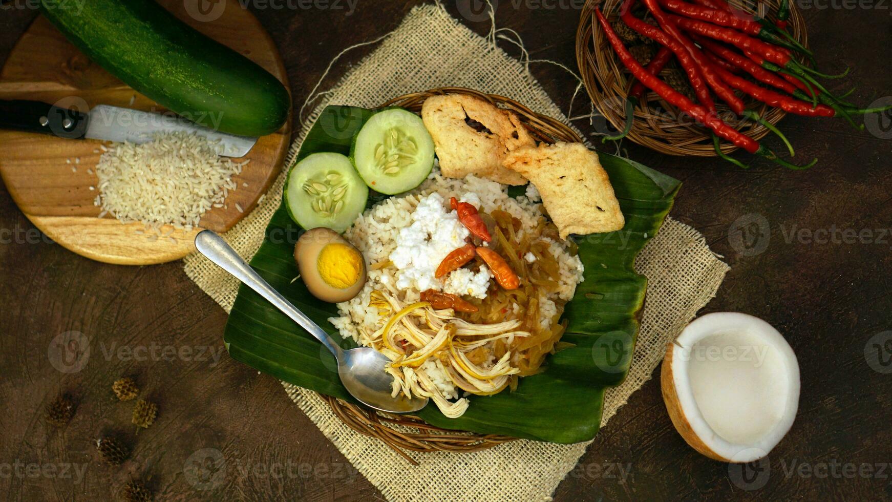 Nasi liwet is a Indonesian traditional food cooked with coconut milk, chicken broth, lemongrass and spices so that it has a savory taste and distinctive aroma. Cucumber and crackers are complementary. photo