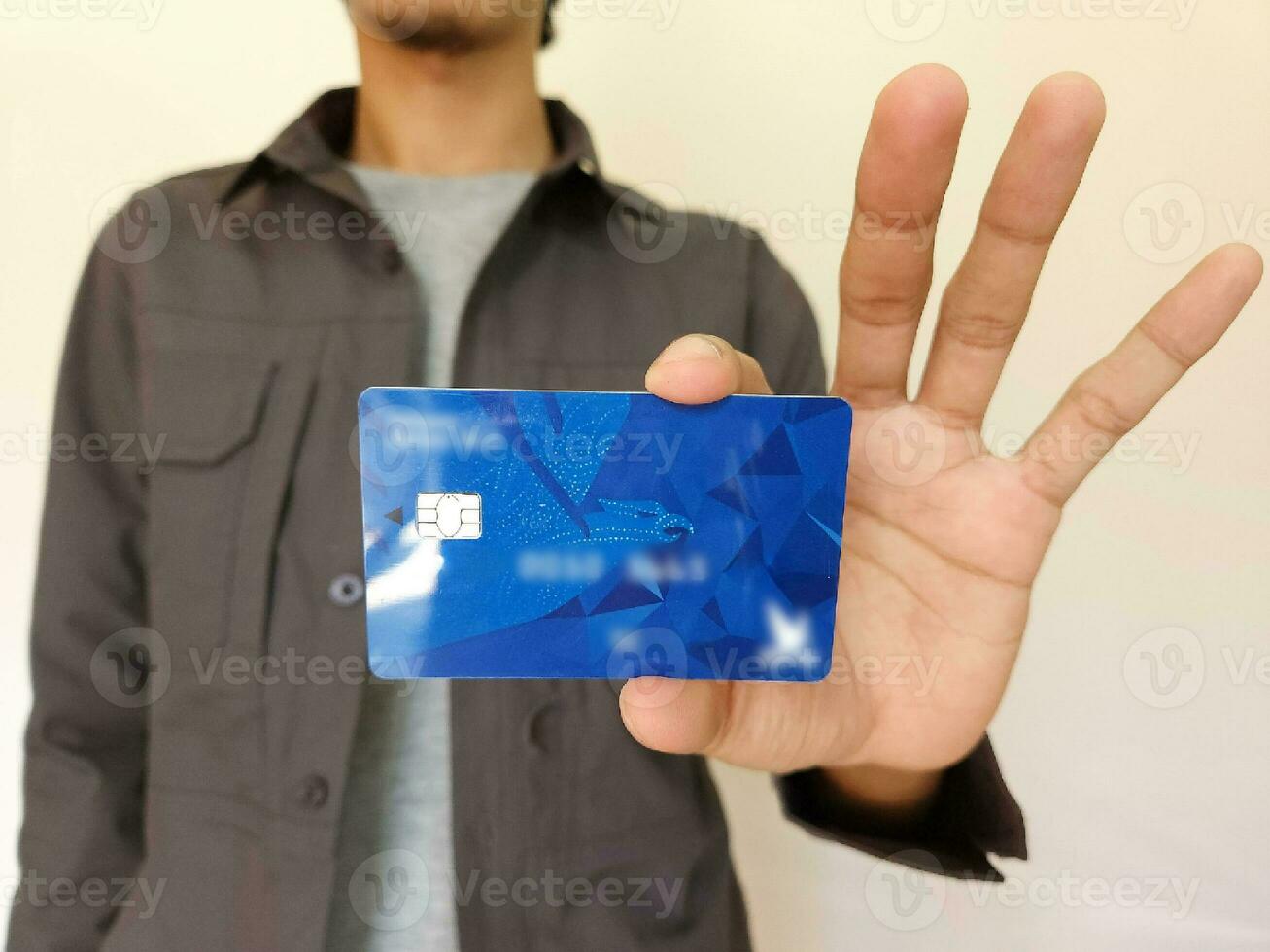 Young man showing credit card photo