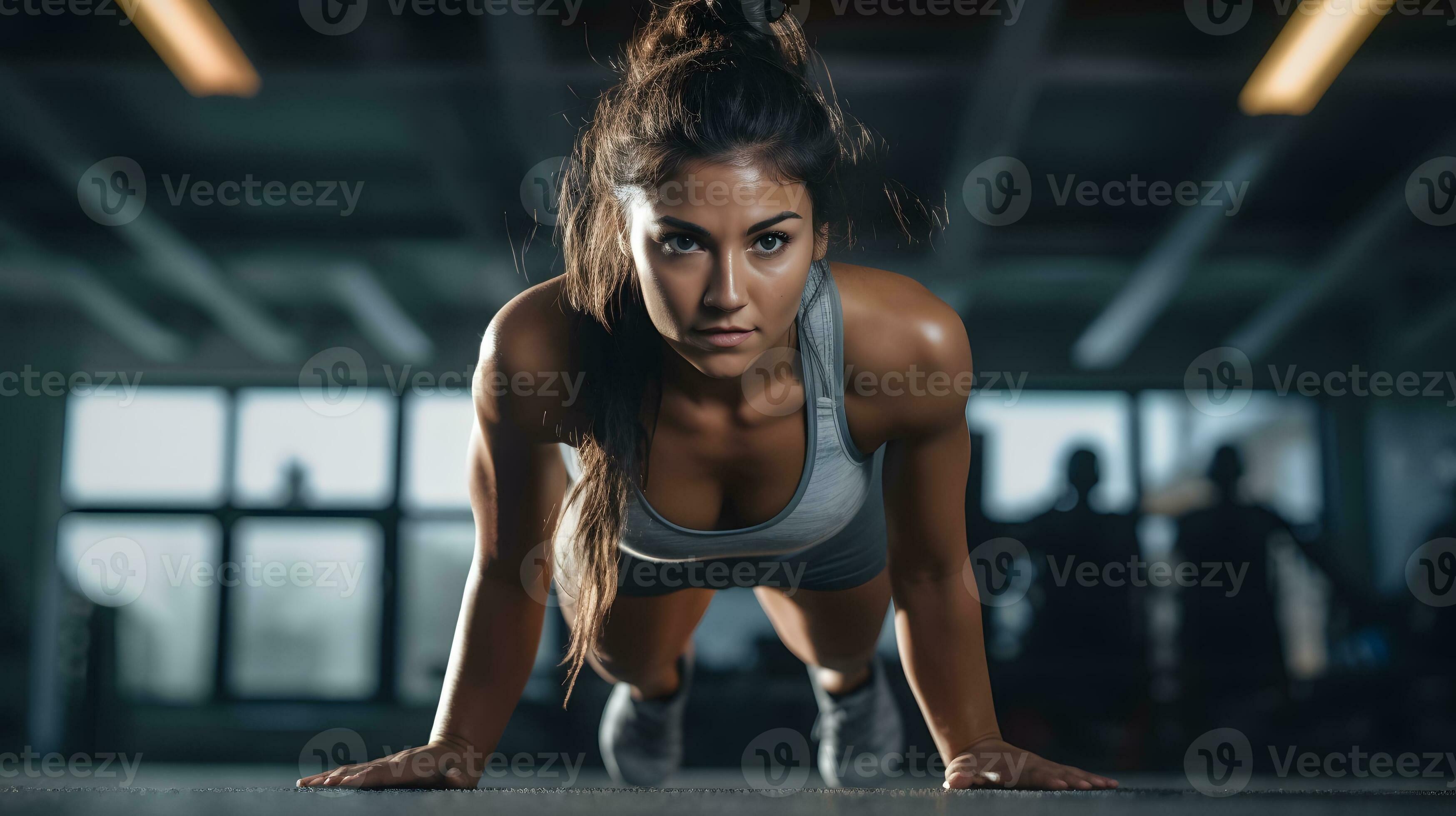 A woman performing intense push up exercises in a gym for high