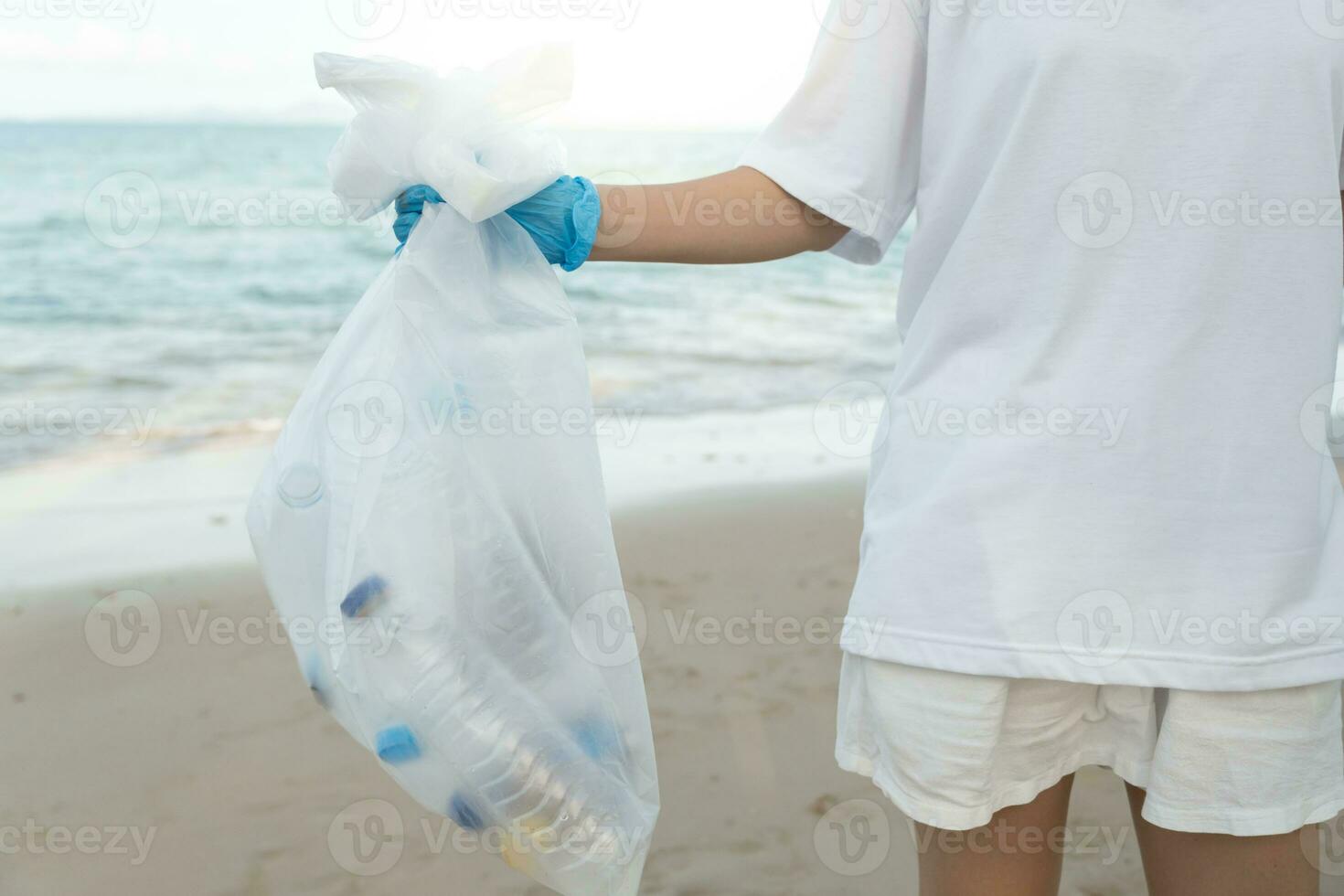 Save ocean. Volunteer pick up trash garbage at the beach and plastic bottles are difficult decompose prevent harm aquatic life. Earth, Environment, Greening planet, reduce global warming, Save world photo