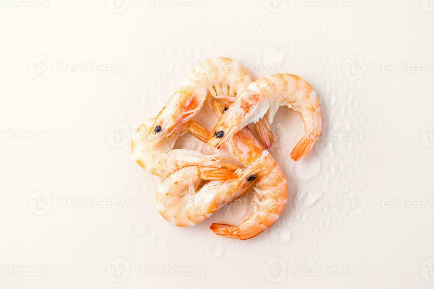 Raw thawed prawns with water drops on a pink background. Mediterranean food. Top view photo