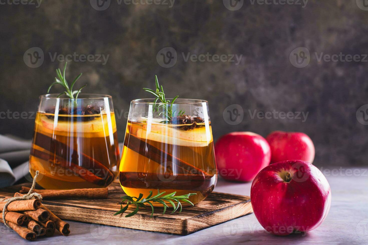 Apple margarita with spices and rosemary in glasses on the table photo