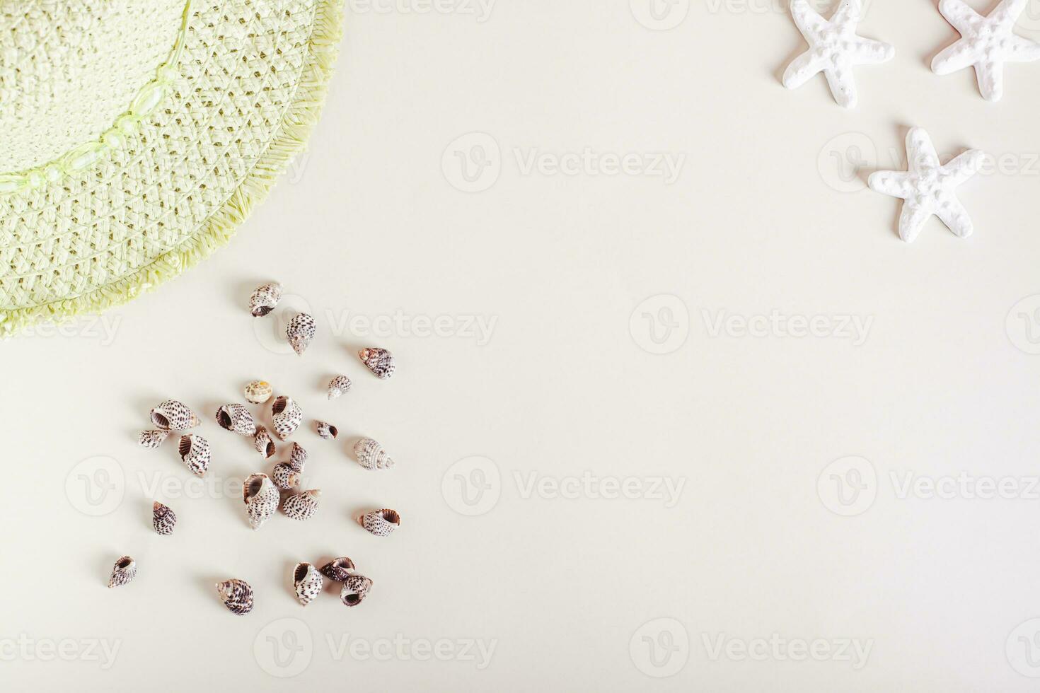 Summer light background for vacation with seashells, starfish and hat top view photo