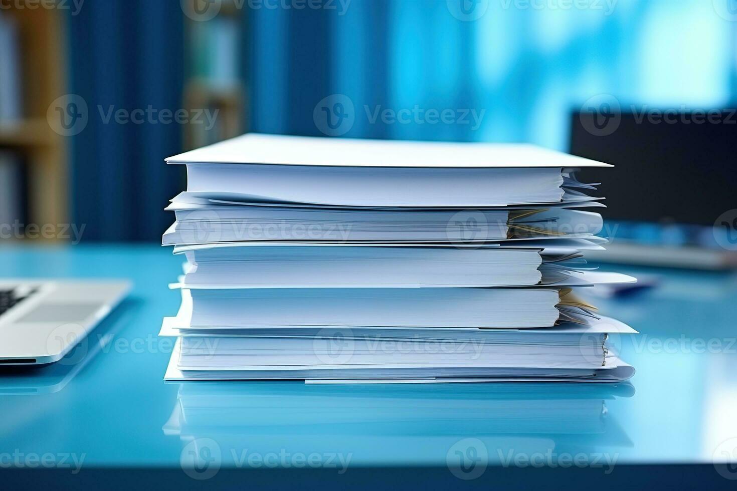 A large stack of papers on the desktop. photo
