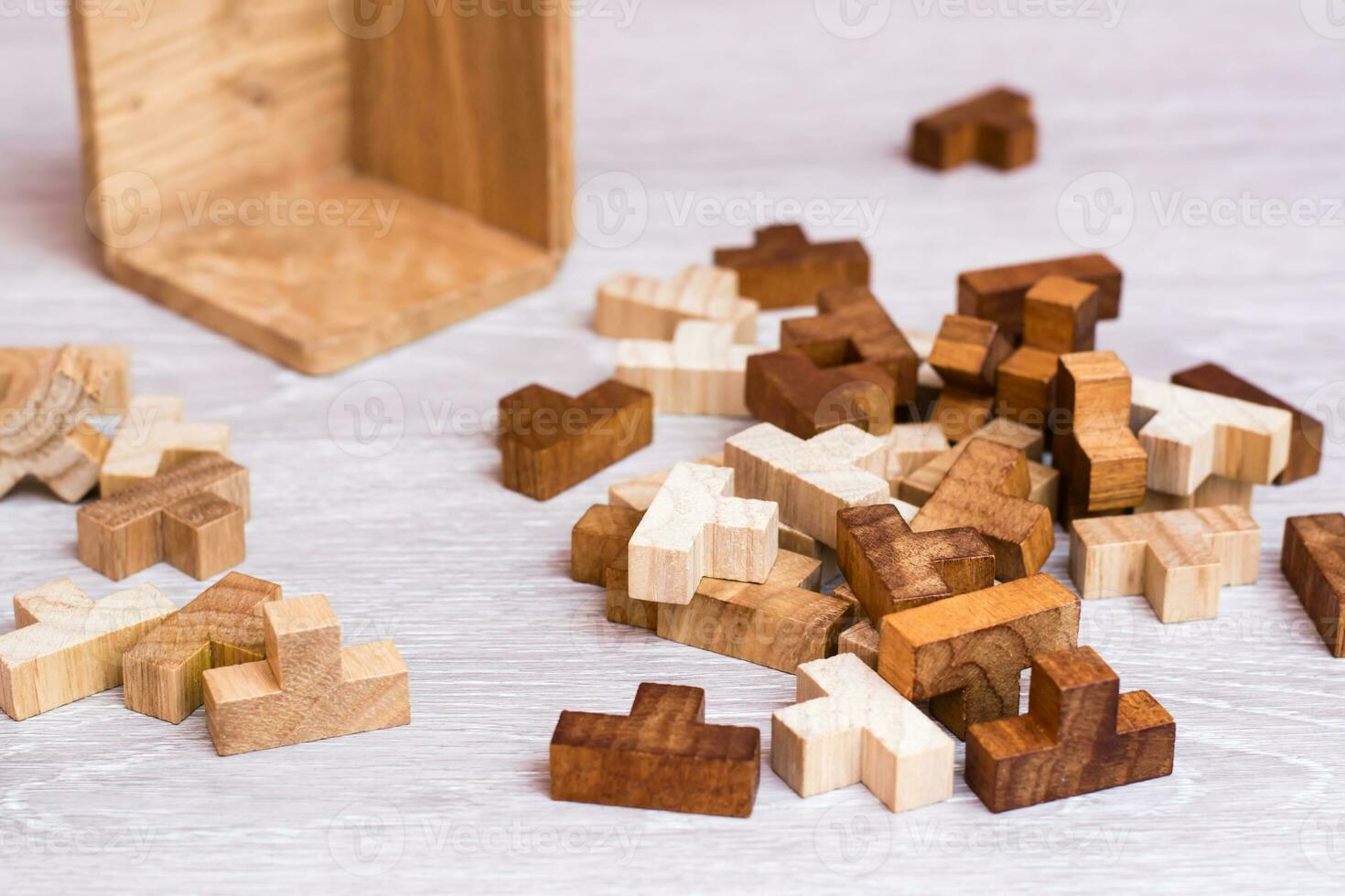 Organization and order. The wooden pieces of the puzzle lie in a mess next to the folding mold photo