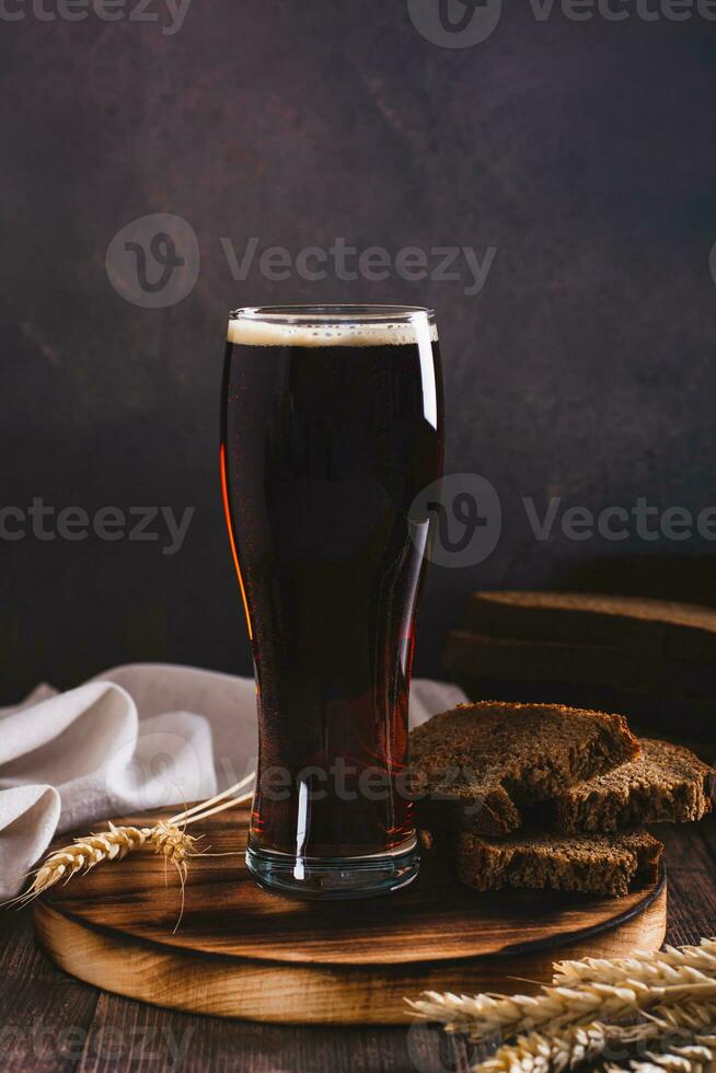 Kvass traditional drink made from fermented bread in a glass on the table vertical view photo