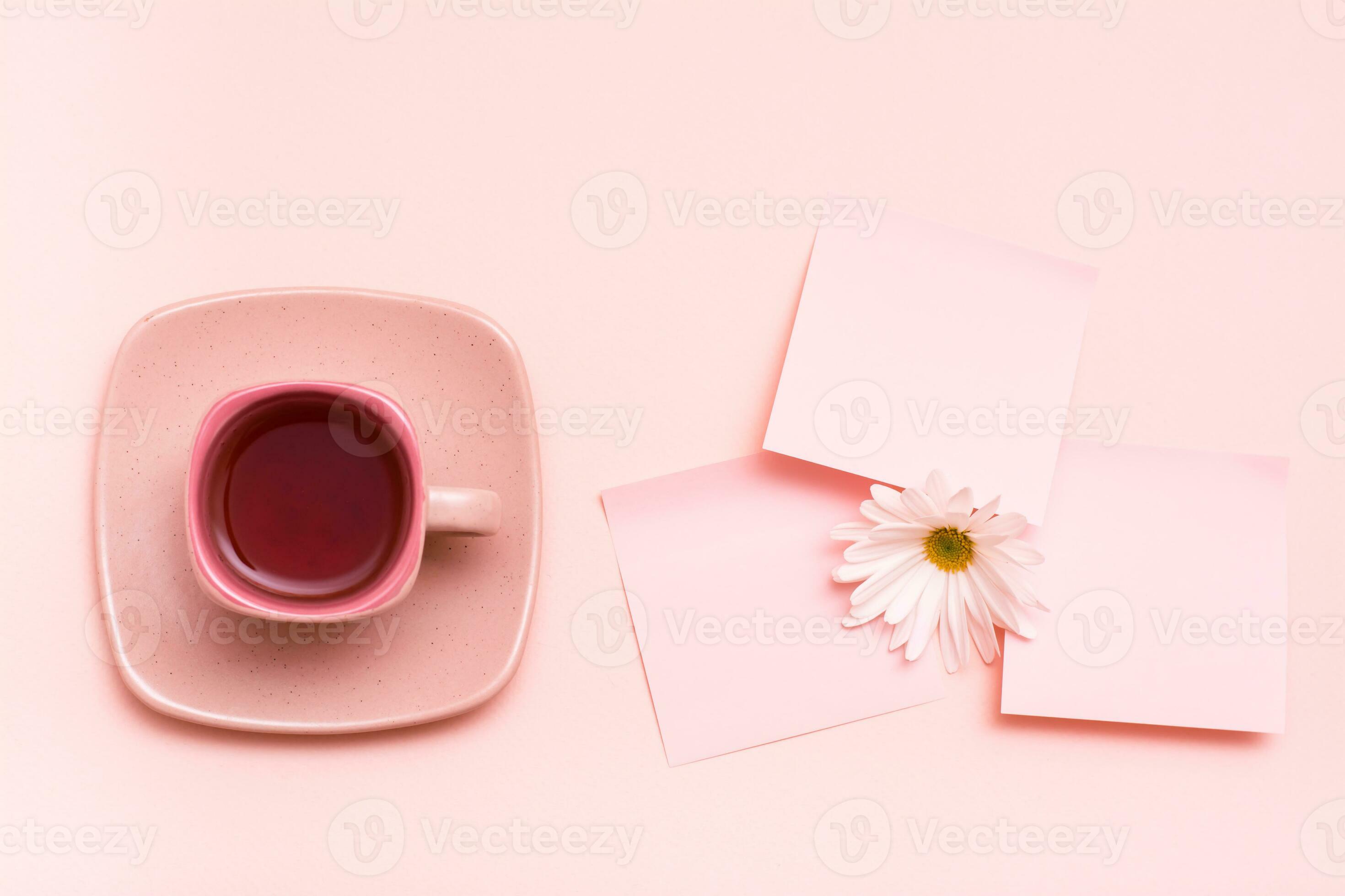 The concept is pink. Pink drink in a coffee cup, leaf for writing and