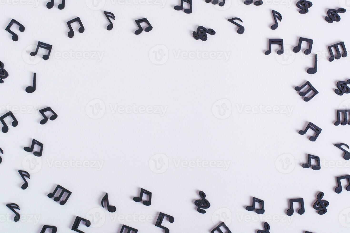 Musical concept frame of black notes on a light background copy space photo