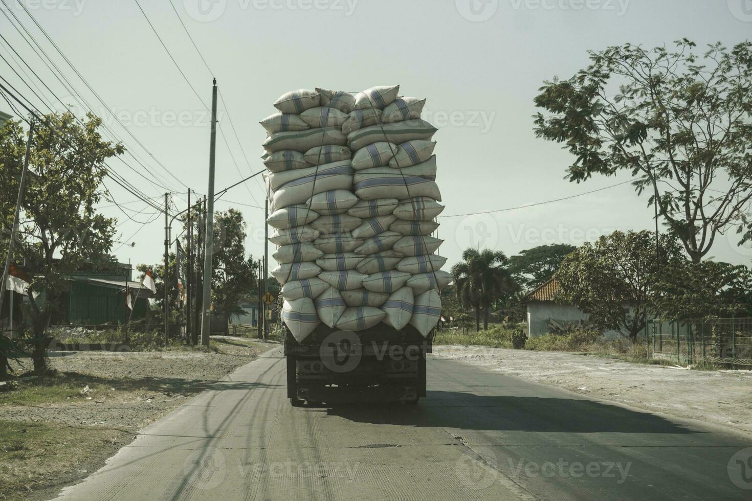 A photo of an overloaded truck on road in Jepara