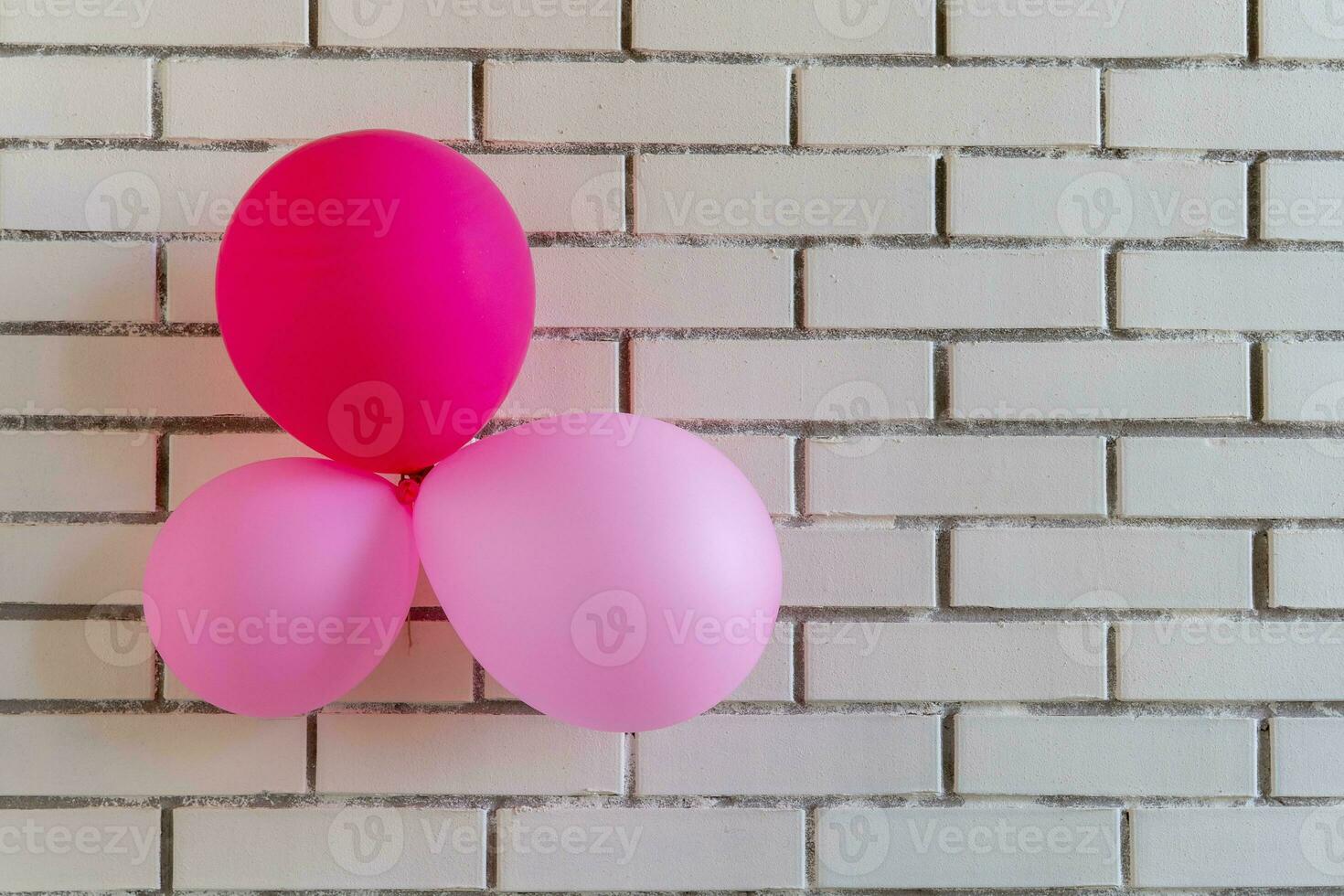 festive red balloons on a brick wall background. Concept holiday birthday. photo