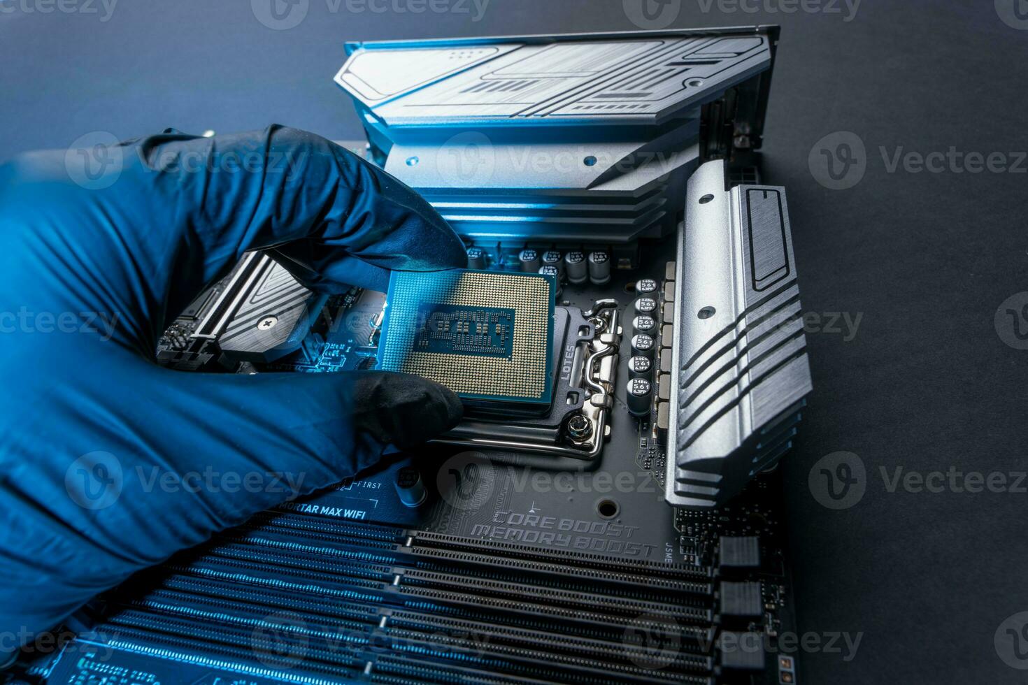 computer processor in a gloved hand against the background of the motherboard photo