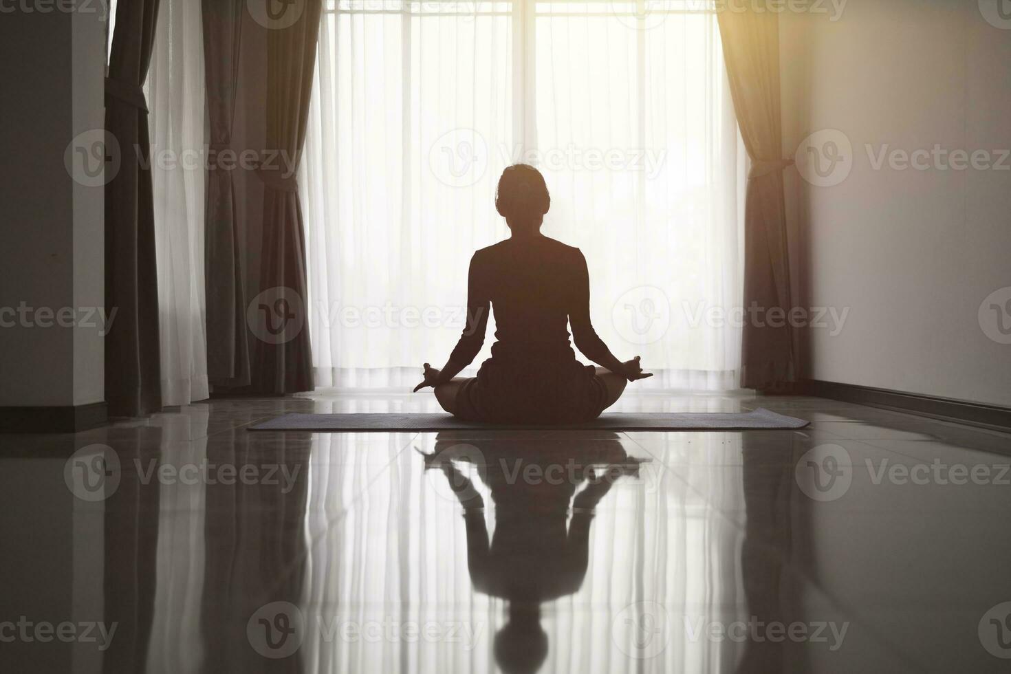 Silhouette of woman Doing yoga at home,  meditation, yoga poses, sport, sunset.  Sports training. photo