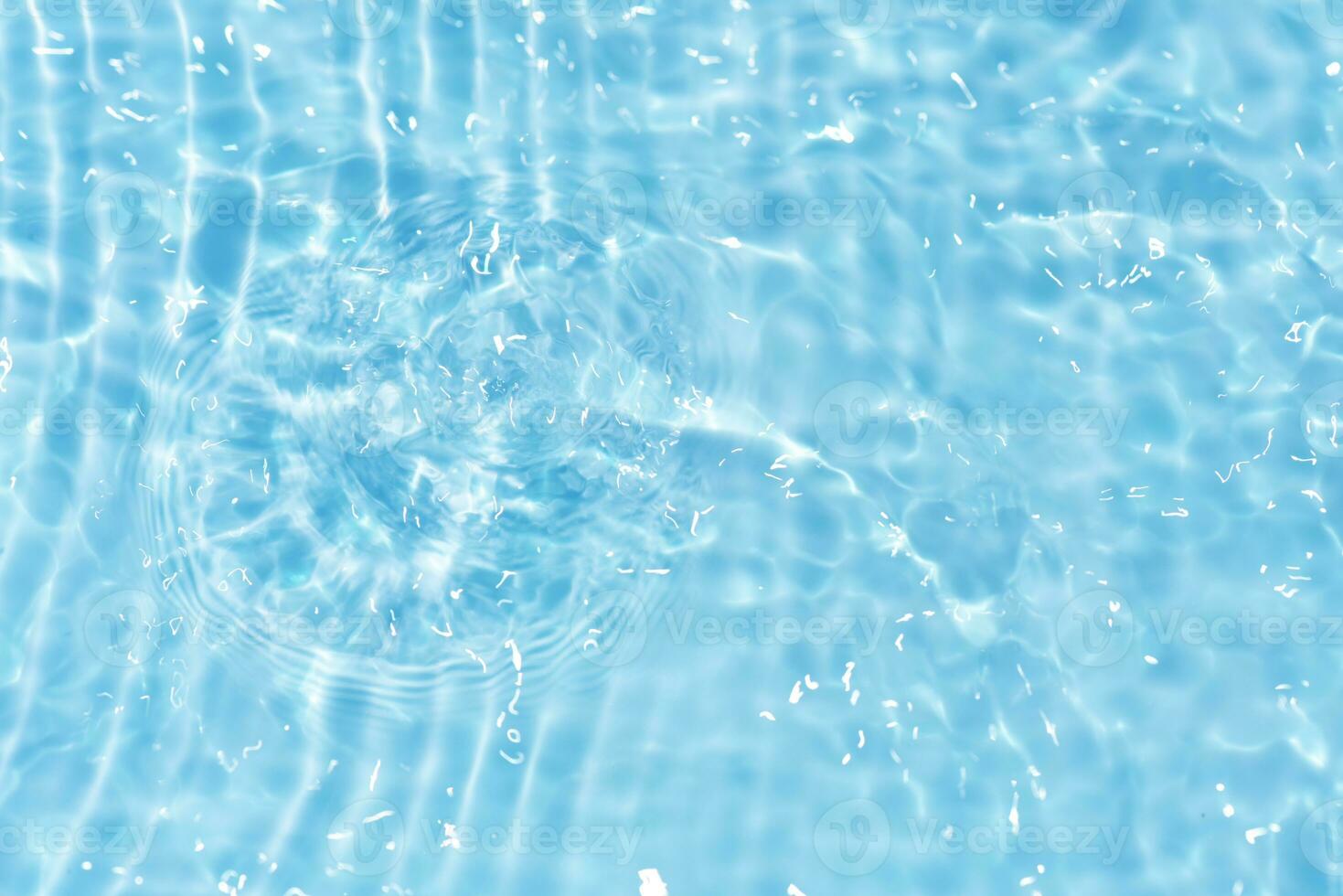 Defocus blurred transparent blue colored clear calm water surface texture with splashes reflection. Trendy abstract nature background. Water waves in sunlight with copy space. Blue watercolor shine. photo