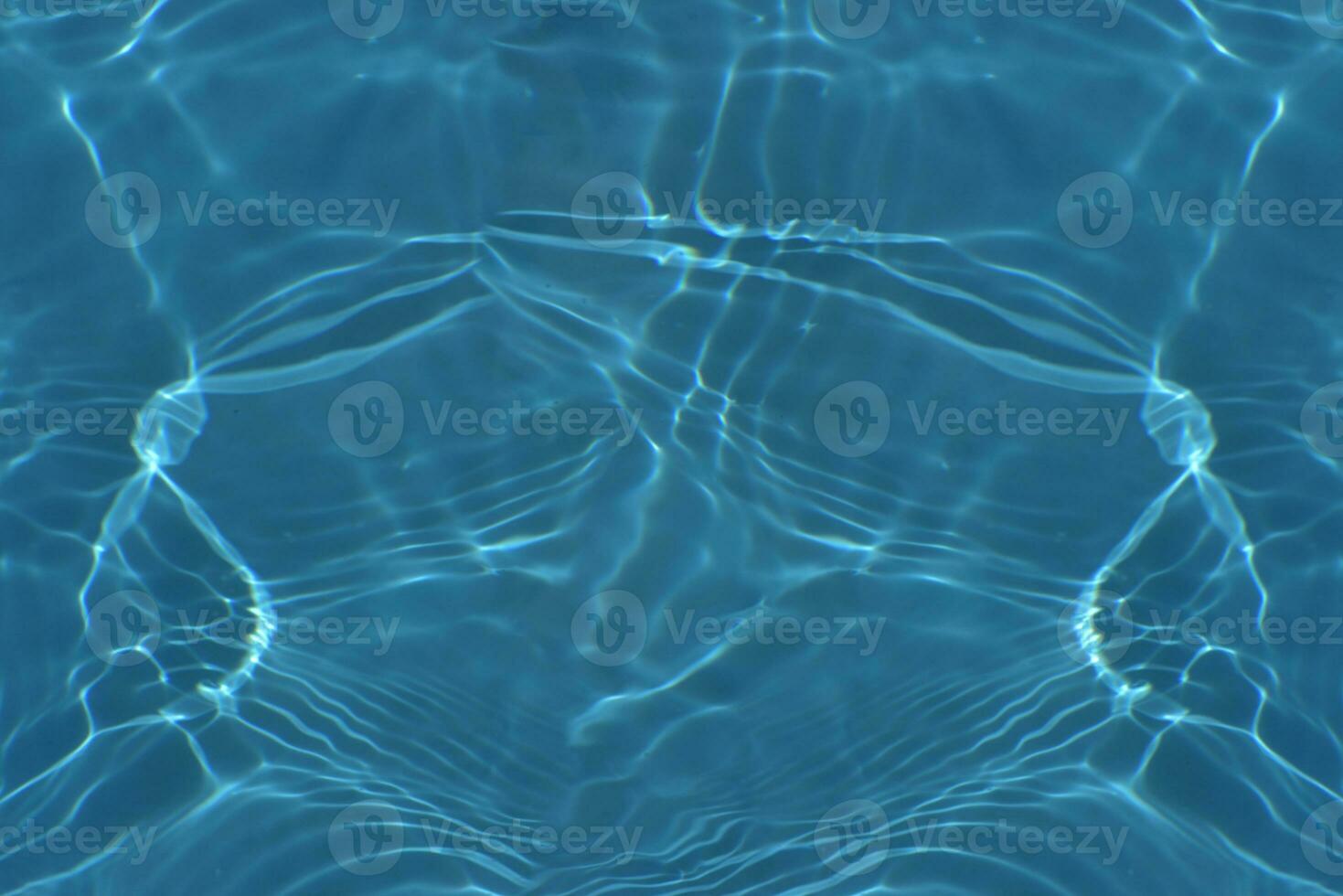 Defocus blurred transparent blue colored clear calm water surface texture with splashes reflection. Trendy abstract nature background. Water waves in sunlight with copy space. Blue watercolor shine. photo
