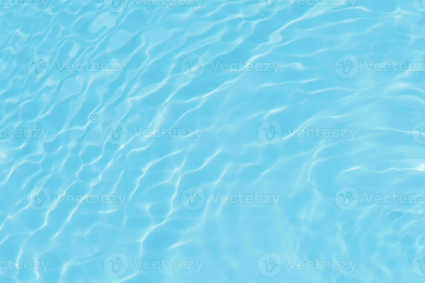 Defocus blurred transparent blue colored clear calm water surface texture with splashes reflection. Trendy abstract nature background. Water waves in sunlight with copy space. Blue watercolor shine. photo