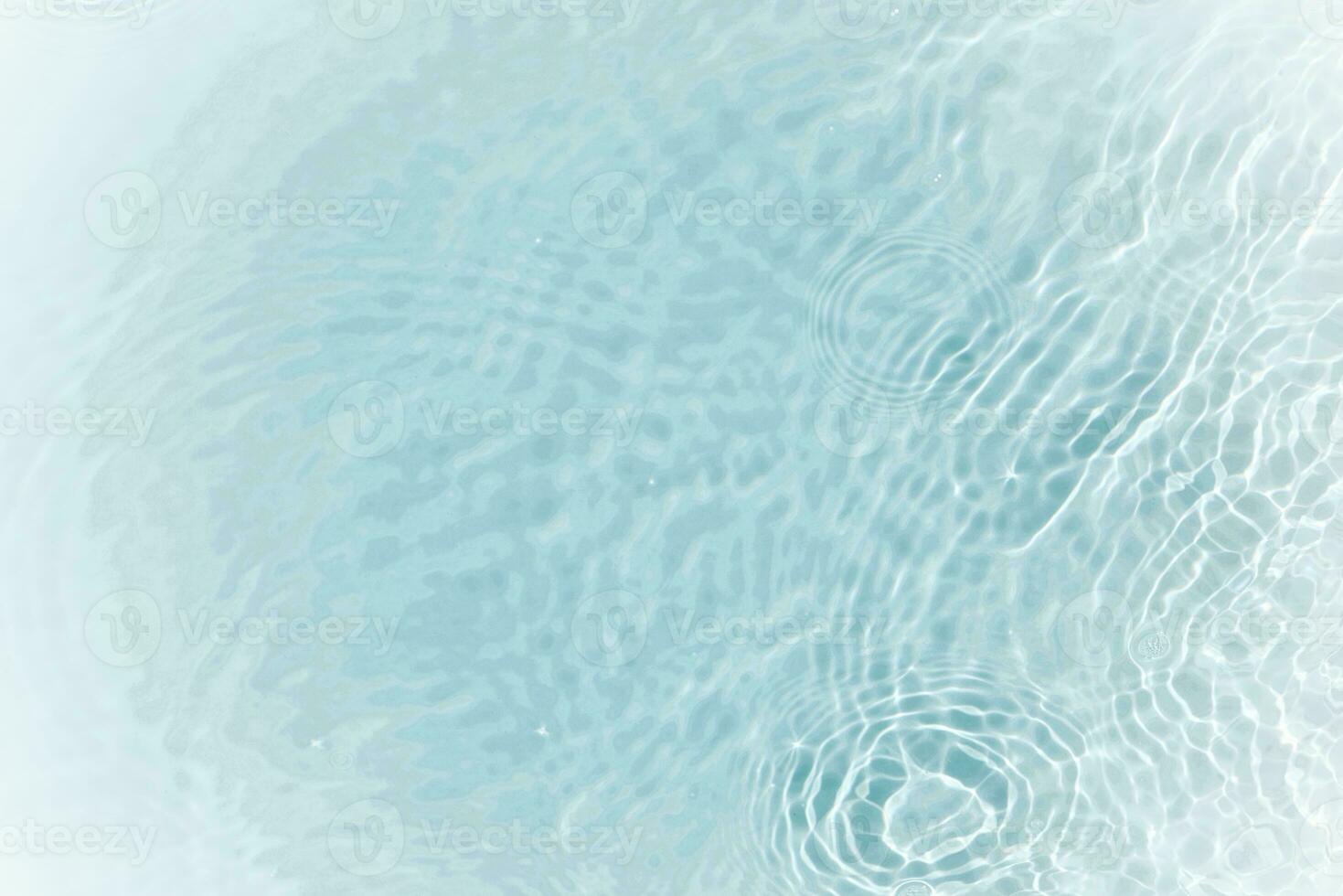 Defocus blurred transparent blue colored clear calm water surface texture with splashes and bubbles. Trendy abstract nature background. Water waves in sunlight with copy space. Blue watercolor shining photo