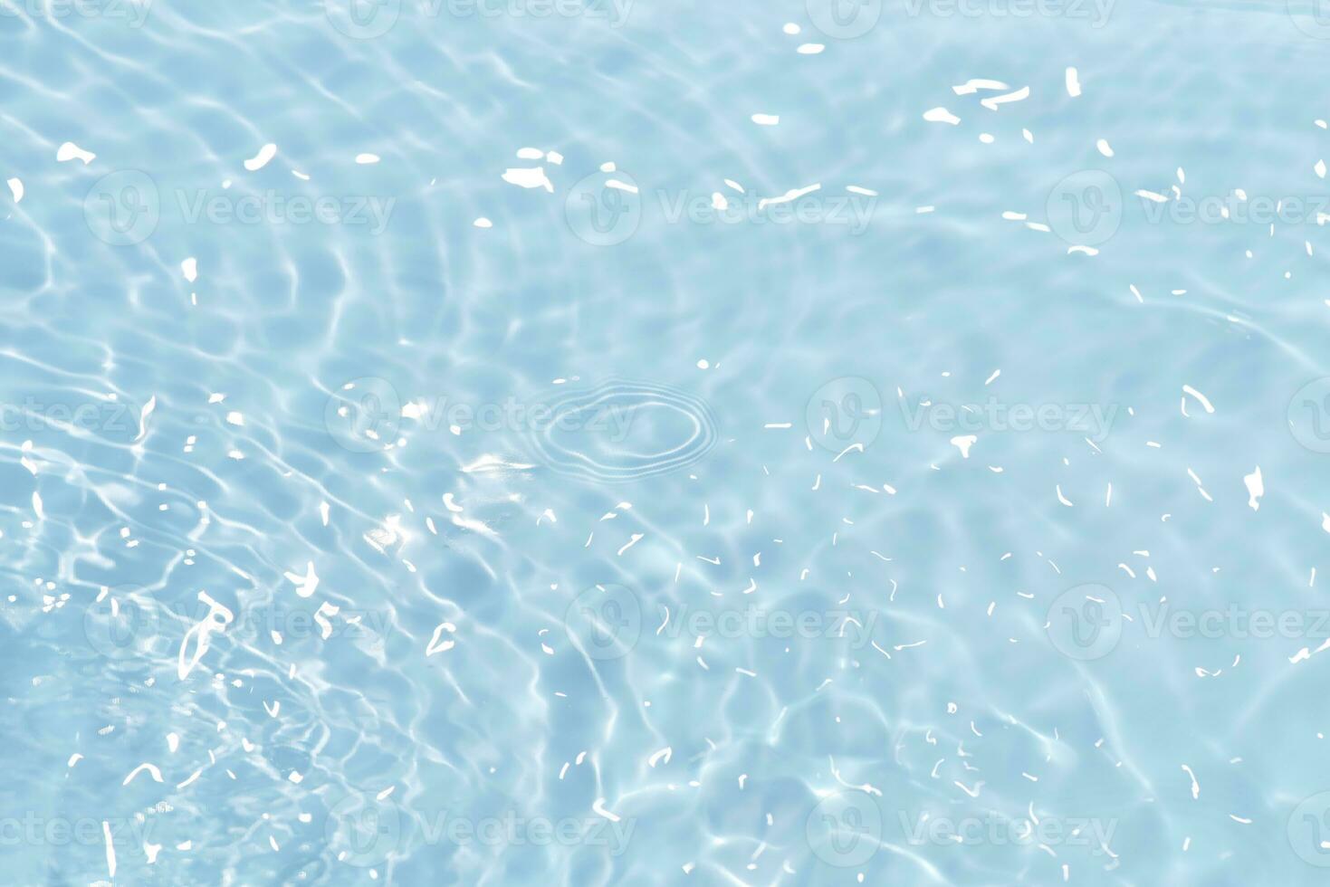 Blue water with ripples on the surface. Defocus blurred transparent blue colored clear calm water surface texture with splashes and bubbles. Water waves with shining pattern texture background. photo