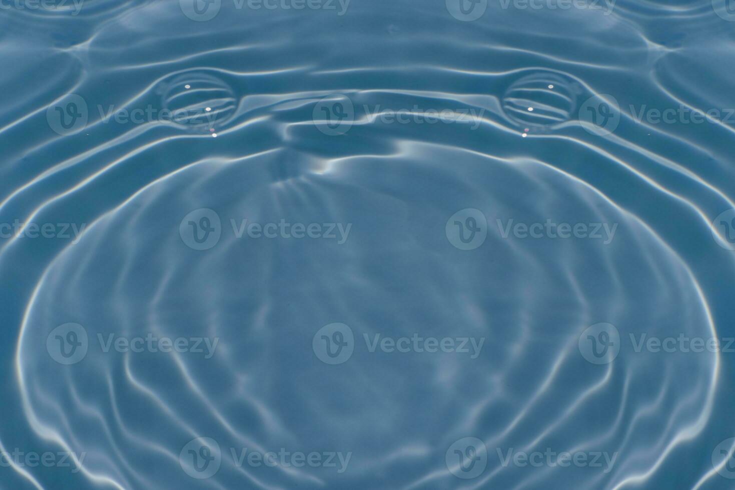 Defocus blurred transparent blue colored clear calm water surface texture with splashes reflection. Trendy abstract nature background. Water waves in sunlight with copy space. Blue watercolor shine. photo