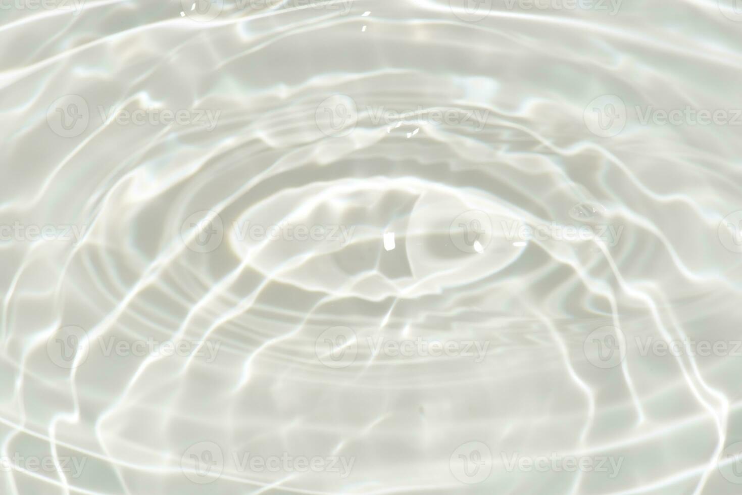 Blue water with ripples on the surface. Defocus blurred transparent blue colored clear calm water surface texture with splashes and bubbles. Water waves with shining pattern texture background. photo