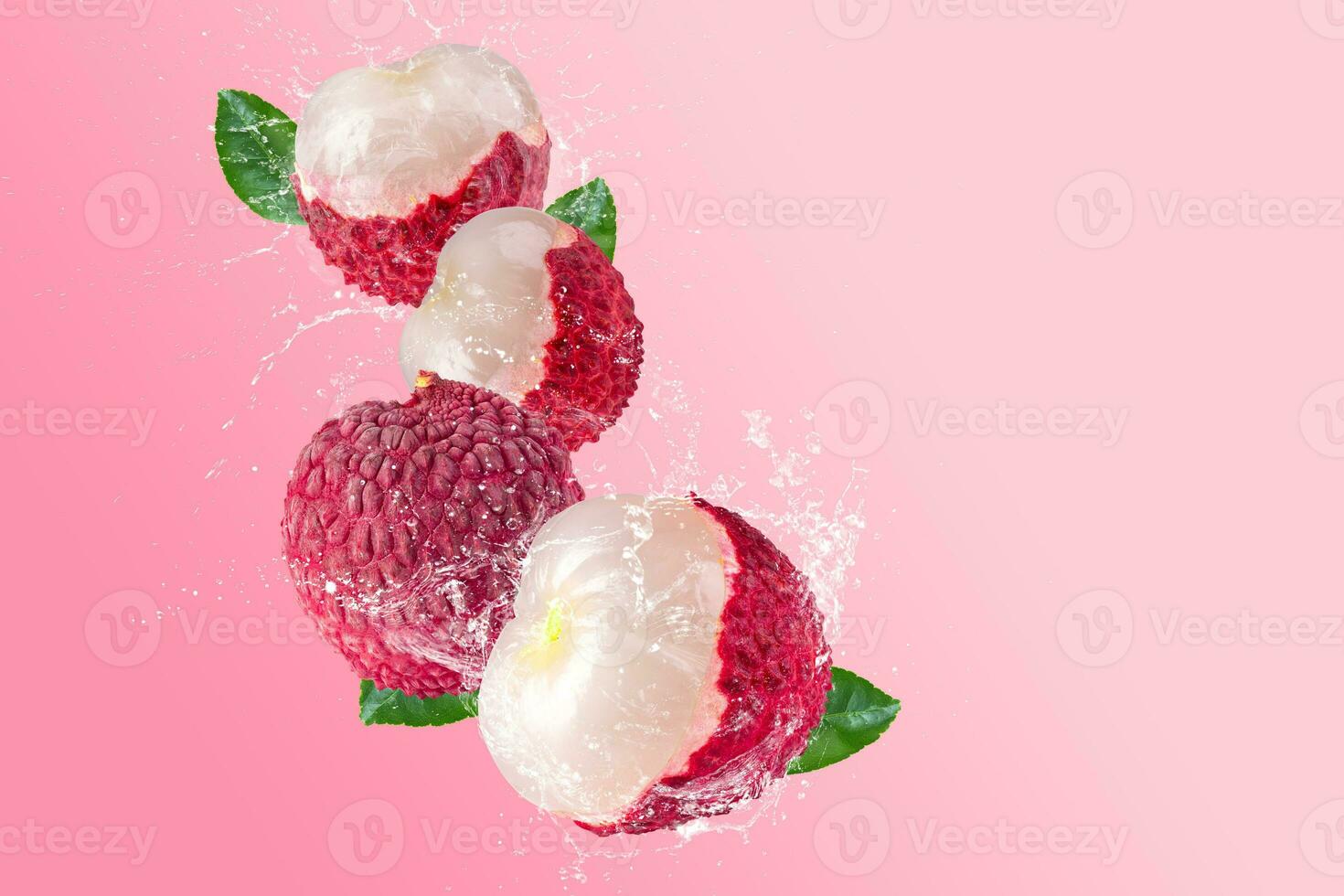 Creative layout made from Fresh lychee or litchi fruit and water splashing on a pastel pink background. Fruit minimal concept and copy space. photo