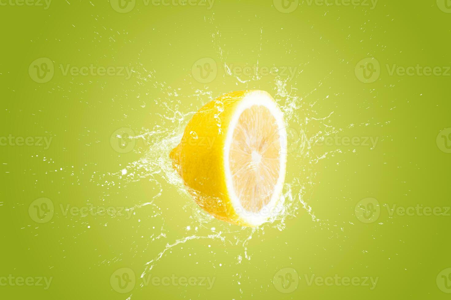Creative layout made from Fresh Sliced lemon fruit and water Splashing on a green background. photo