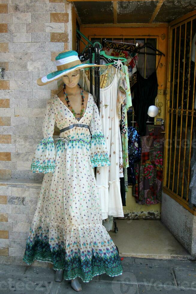 A mannequin stands on a display window in a supermarket. photo