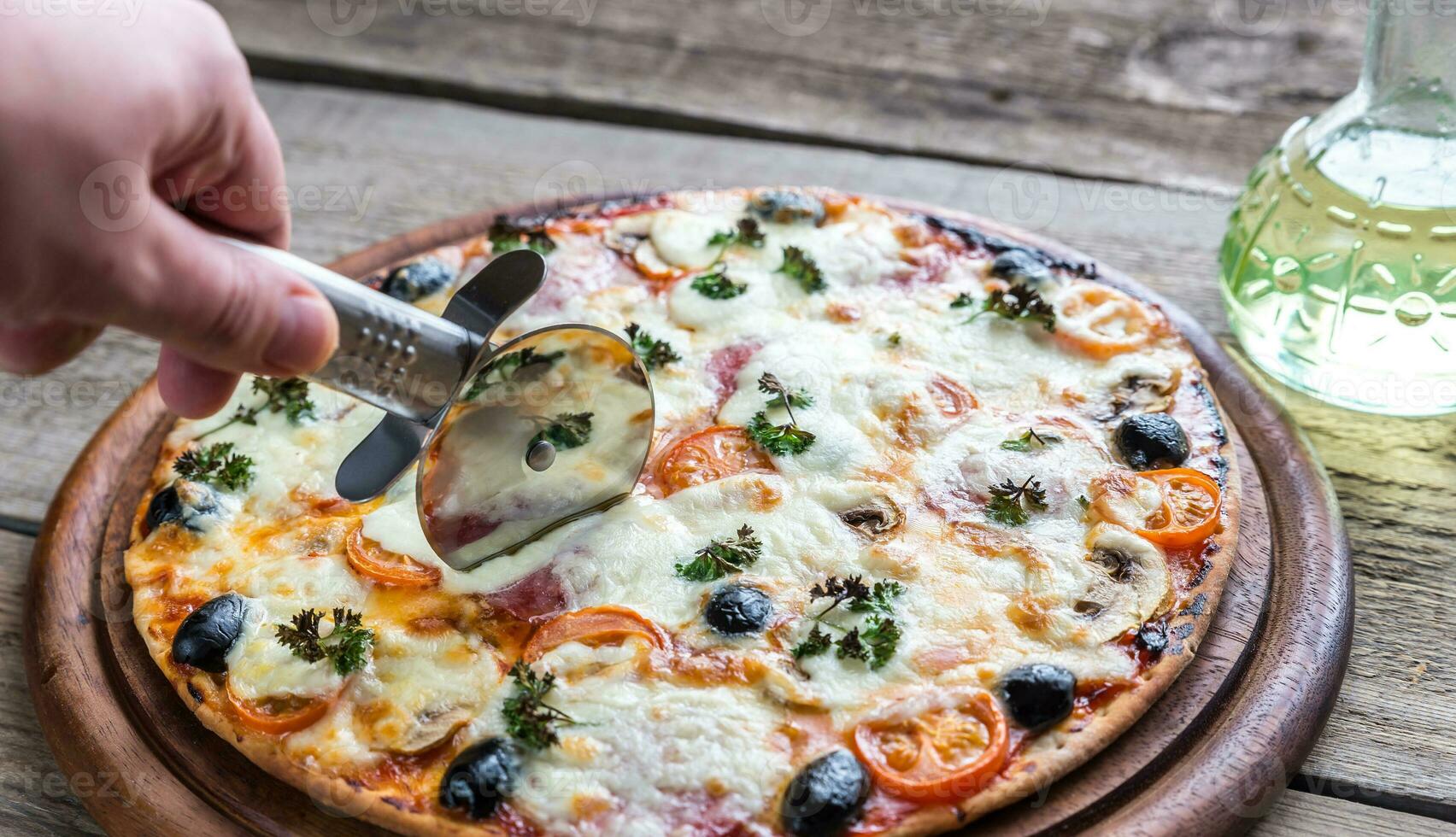 Cooked pizza on the wooden board photo