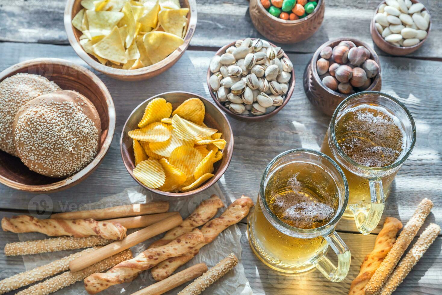Two glasses of beer with appetizers photo