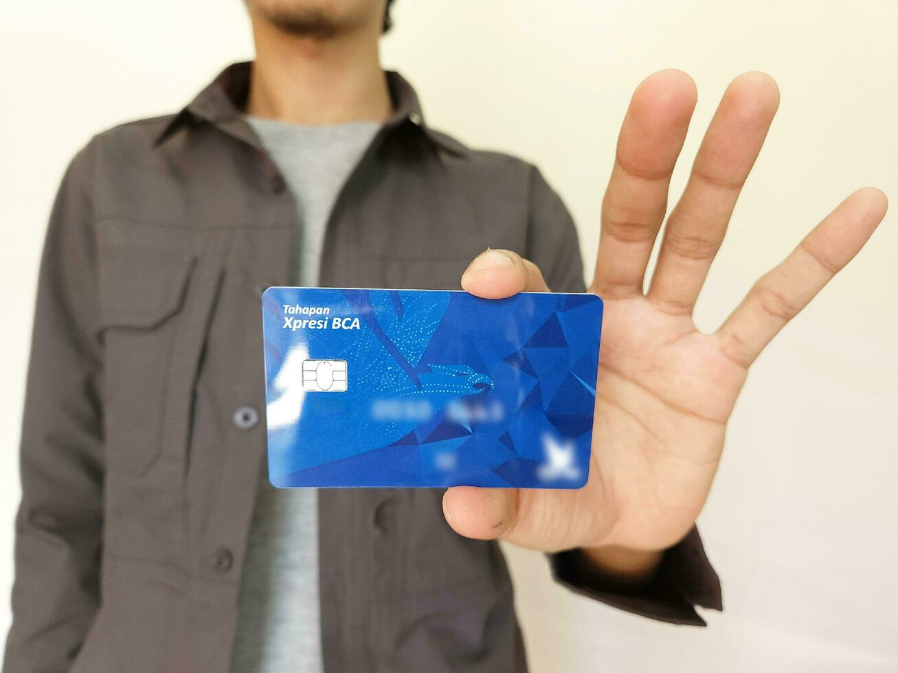 man showing BCA debit Card photo