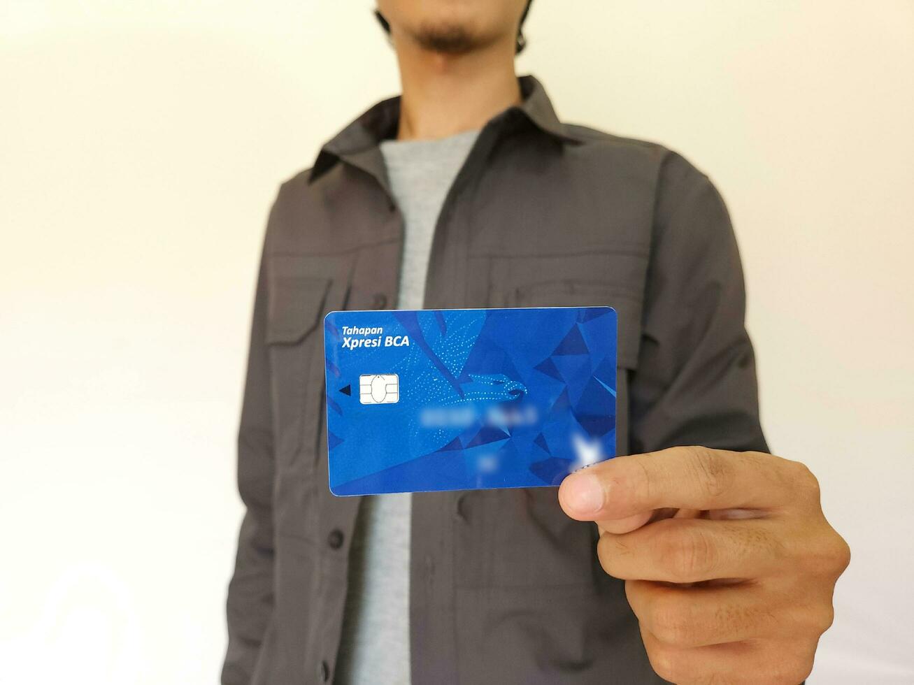 man showing BCA debit Card photo