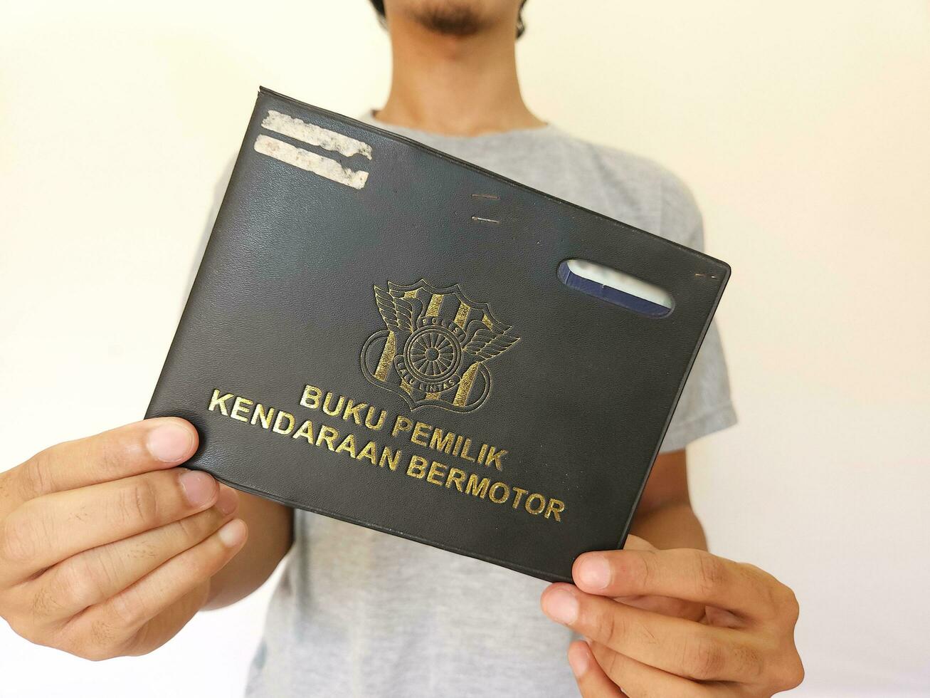 Indonesian book vehicle owners or commonly known as Buku Pemilik Kendaraan Bermotor BPKB. holding BPKB photo