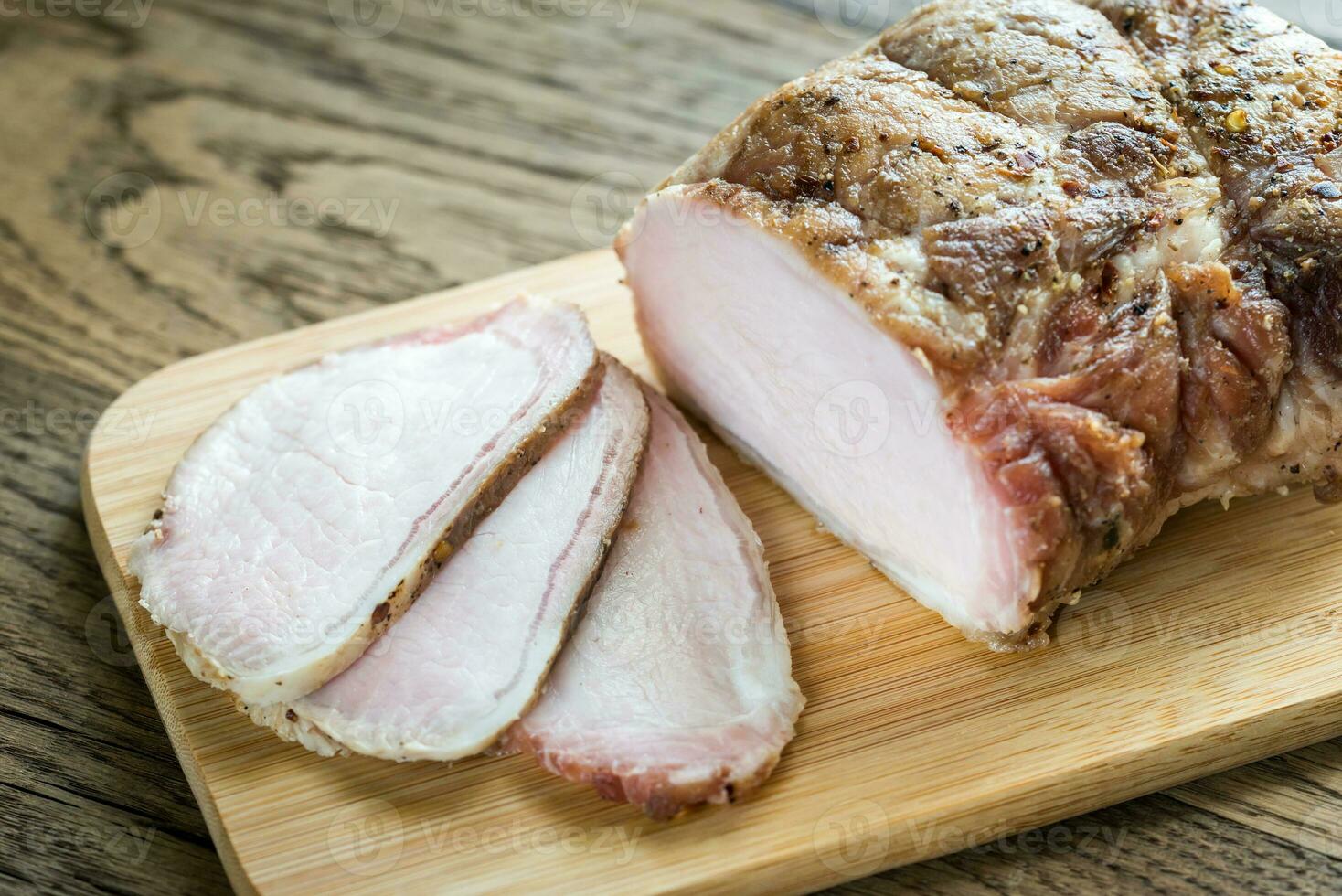 Baked meat on the wooden board photo