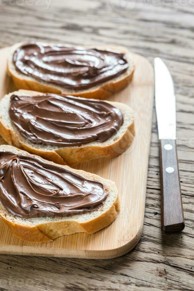 Slices of baguette with chocolate cream photo